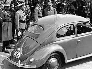 Hitler looking at a VW beetle.